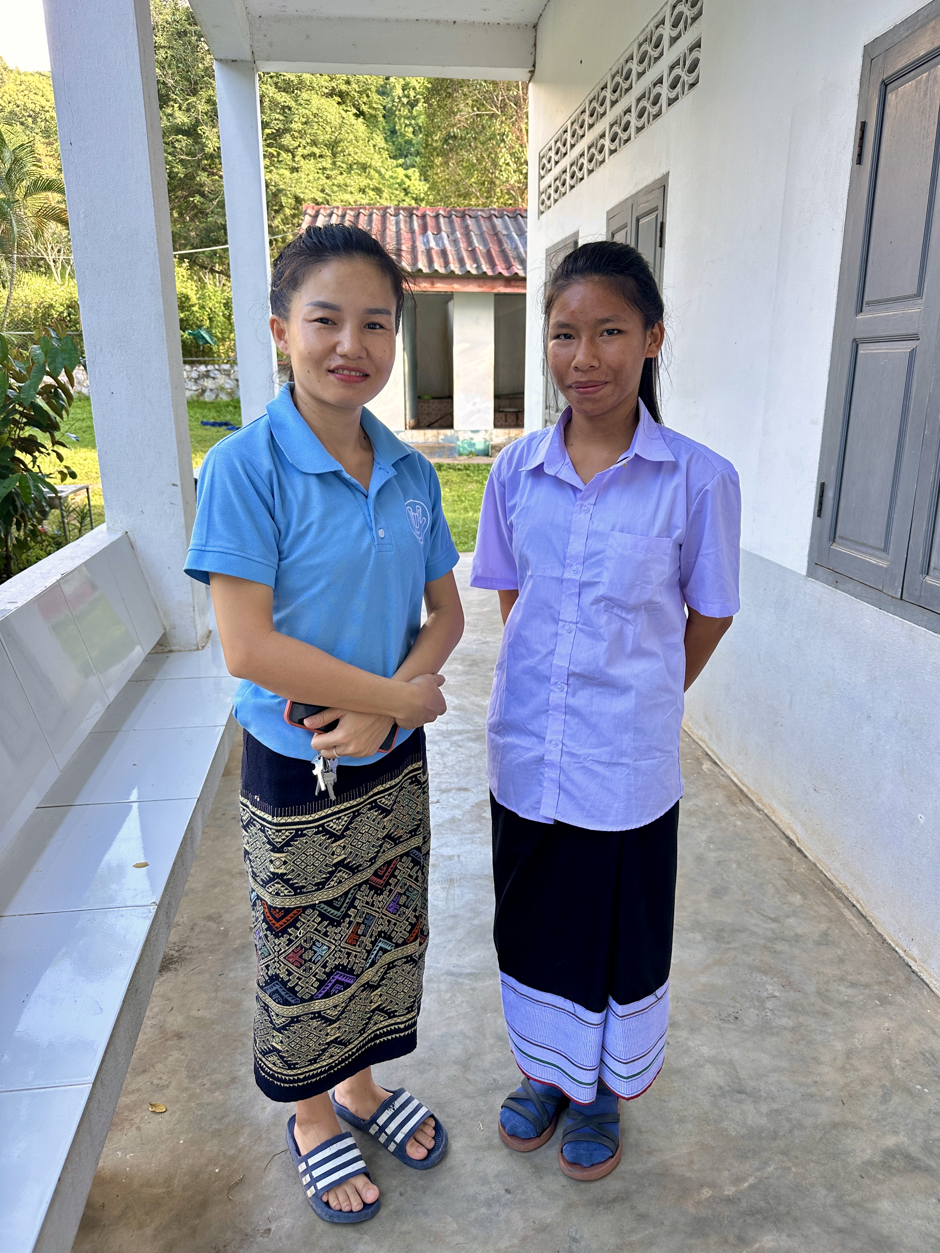 Julie with a student in a lavender shirt at Luang Prabang School for the Deaf