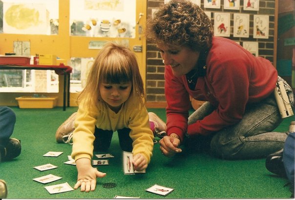 Julie supporting a young Deaf child using picture cards