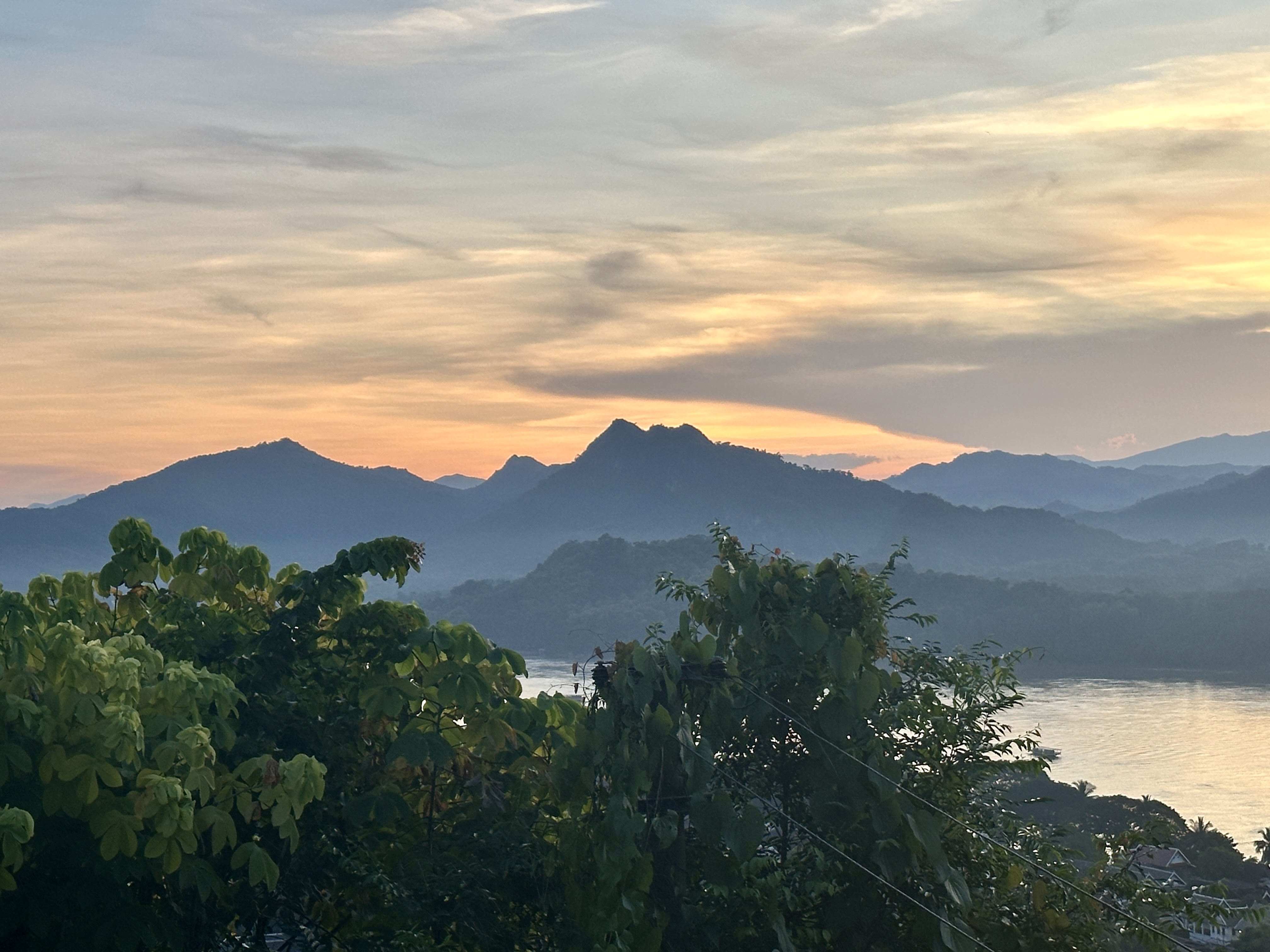 Warm sunrise over misty mountains and river