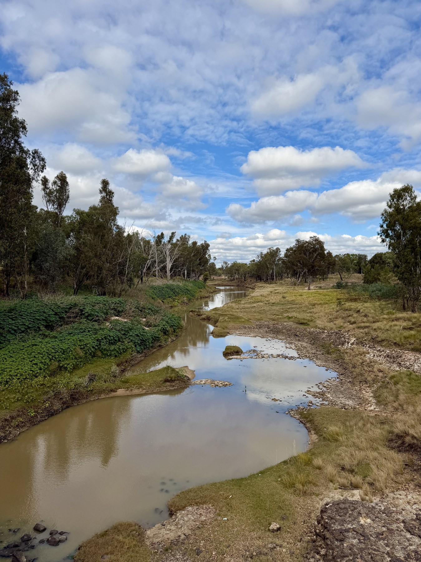 Condamine River viewed from Crawford Bridge under a cloud-filled sky