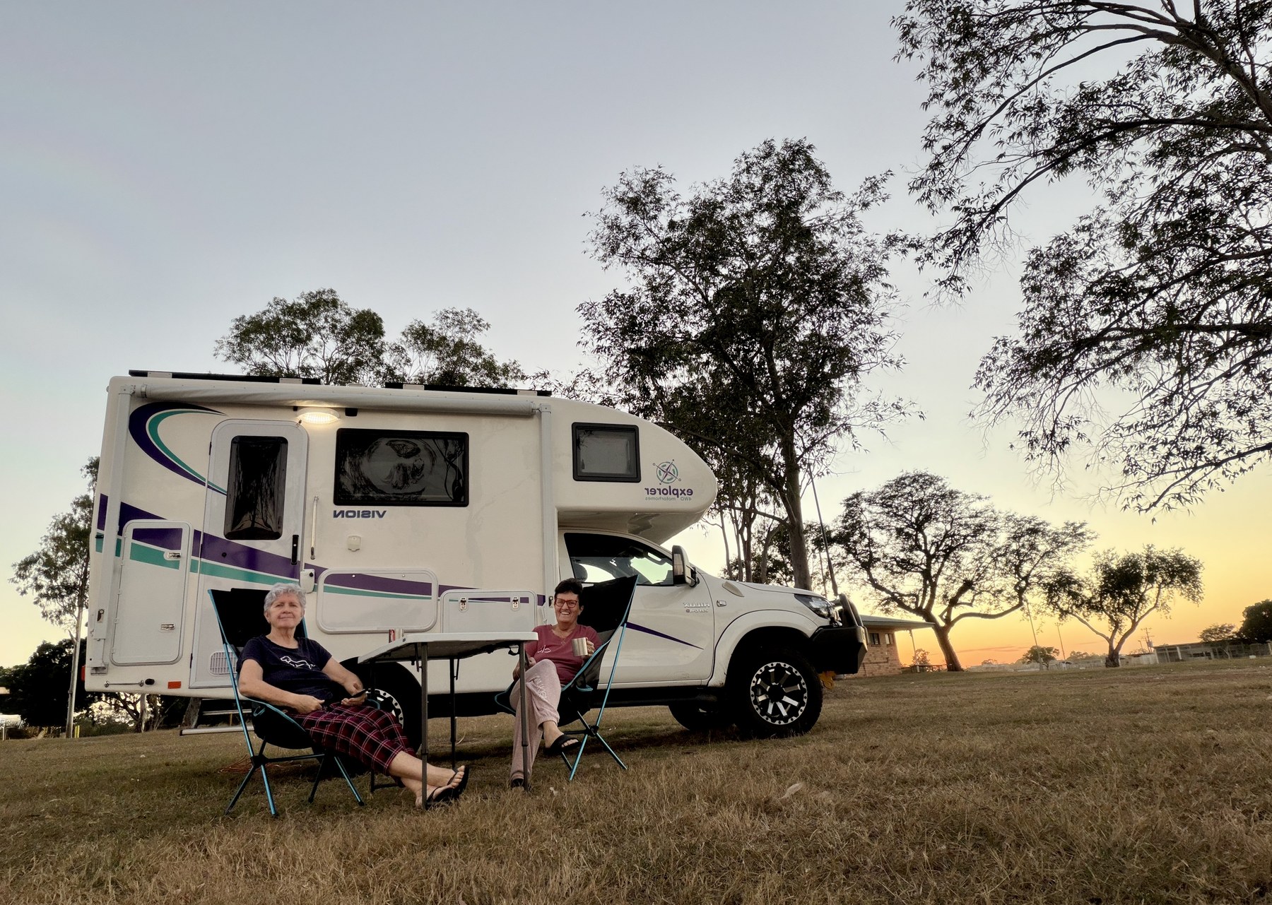 Kel and Julie sitting outside Elcee at Clermont Showgrounds at sunset