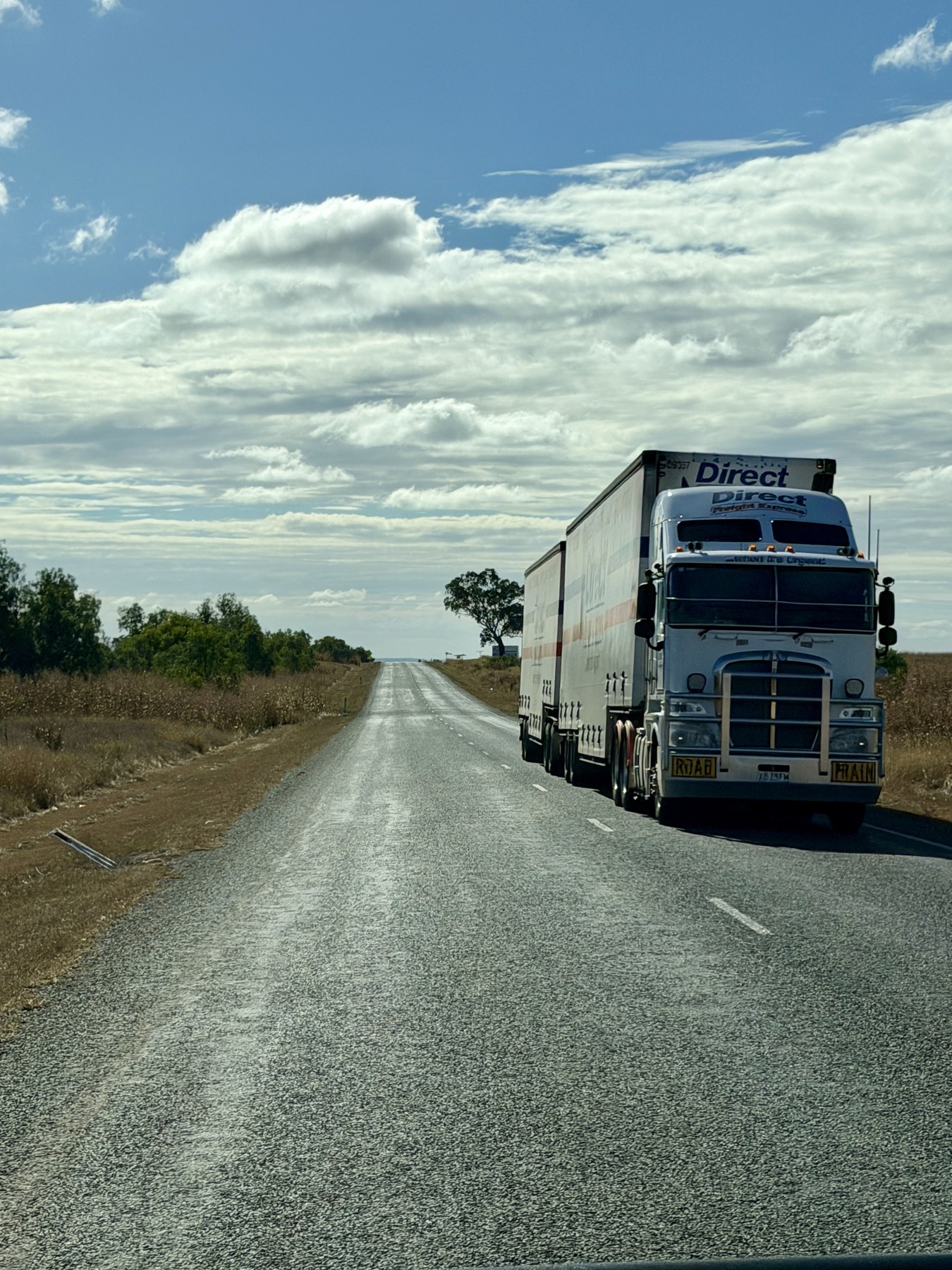 A smaller roadtrain travelling along the highway outside Capella