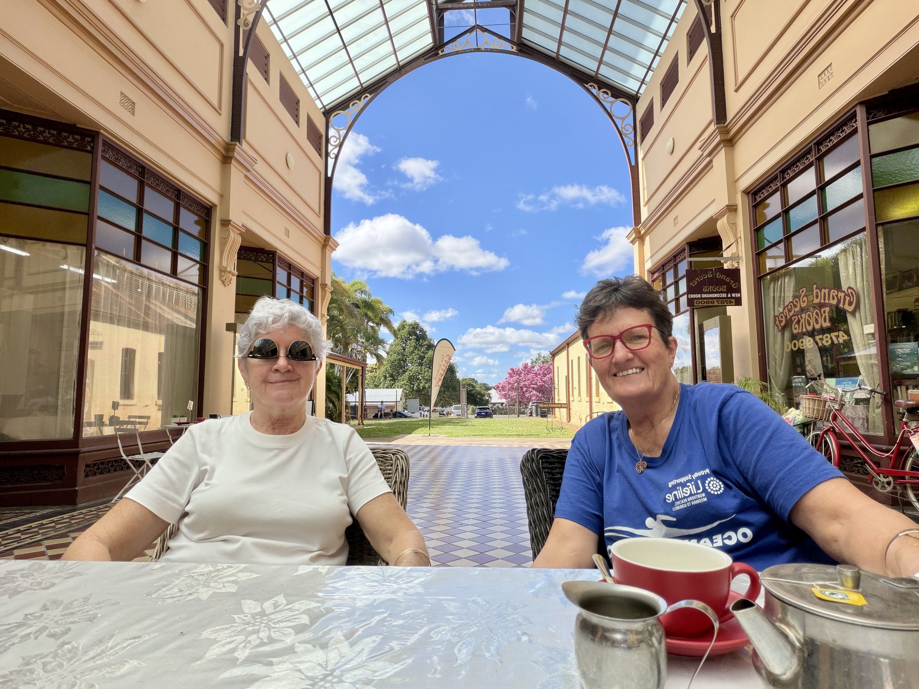 Kel and Julie sitting in the historic Stock Exchange Arcade in Charters Towers