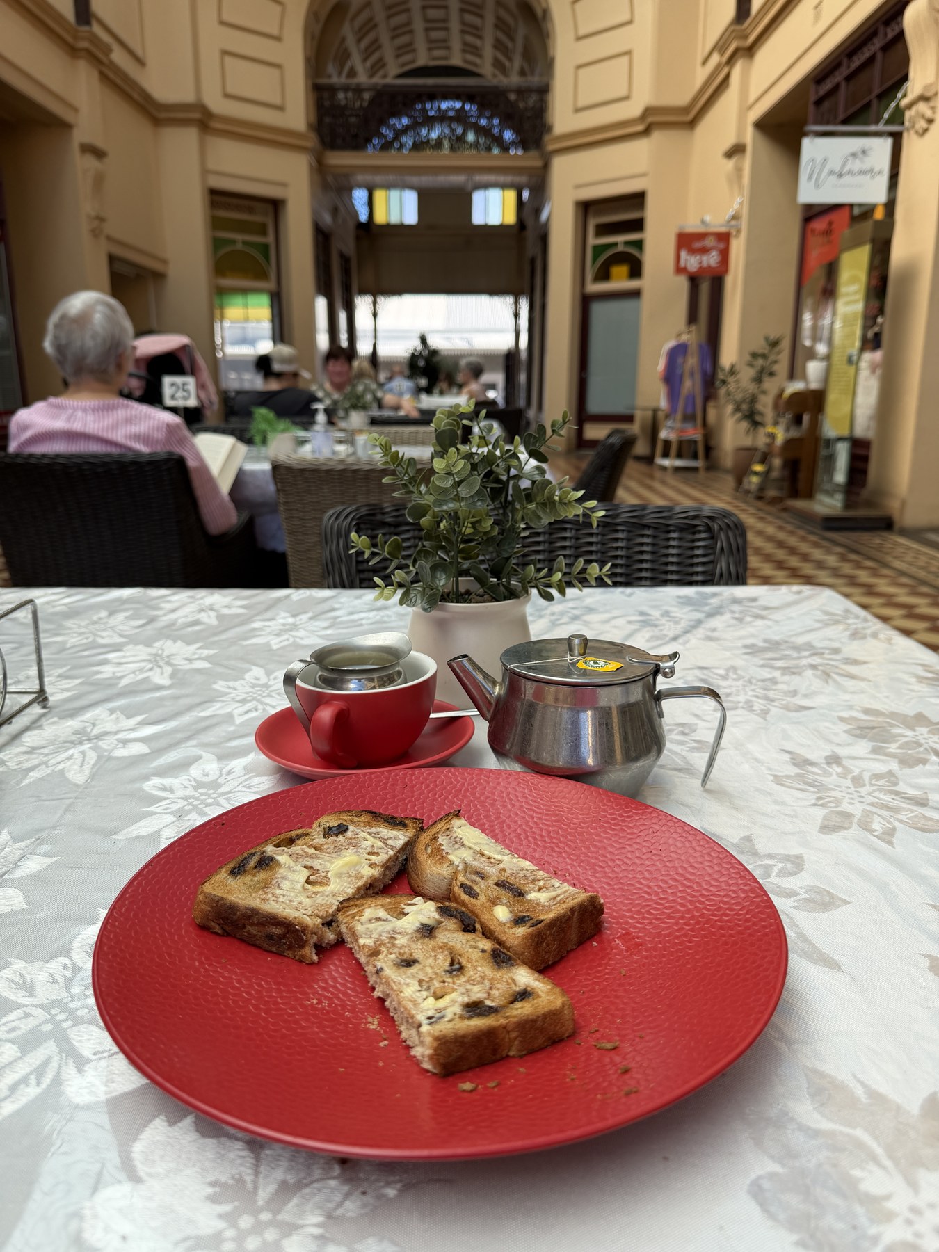 A teapot and toast on a cafe table at the Stock Exchange Arcade