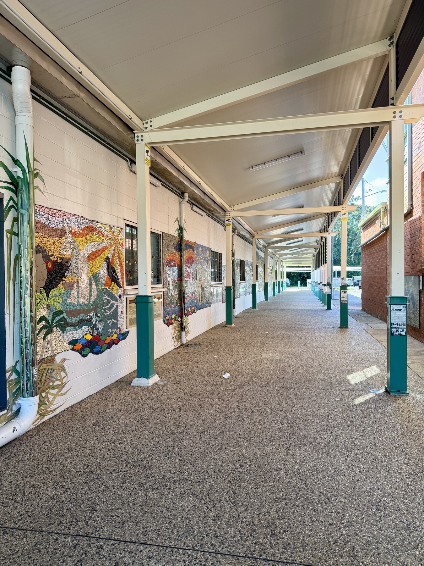 Covered Ravenshoe railway platform with painted mural panels