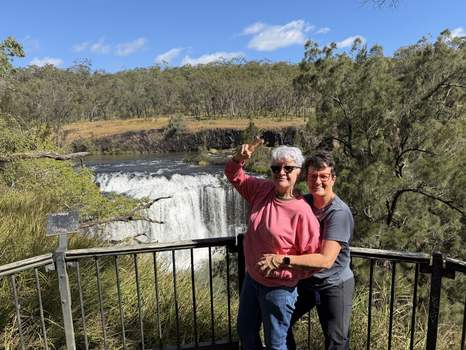 Julie and Kel smiling at the Millstream Falls lookout