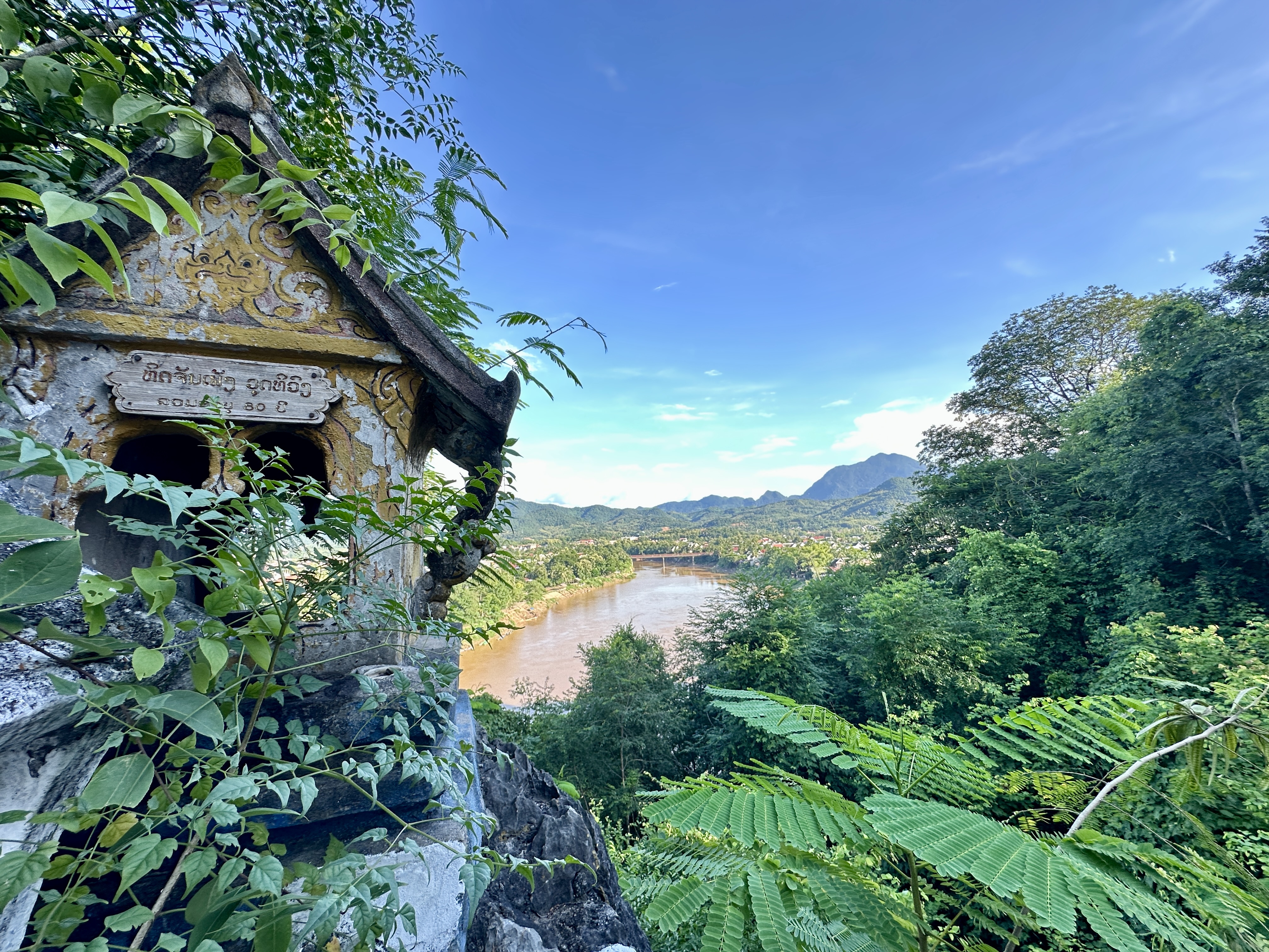Temple detail overlooking the Luang Prabang river and green hills